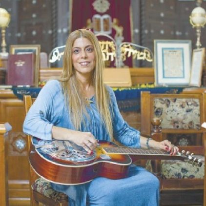 Rabbi Peres playing dobro on the bimah